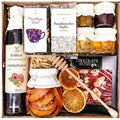 Geschenkkorb mit Honig Tee Schokolade Konfitüre Sirup handverlesene natürliche Delikatessen im Korb